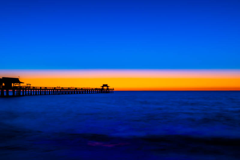 Naples Pier at sunset — orange sky over the calm Gulf of Mexico